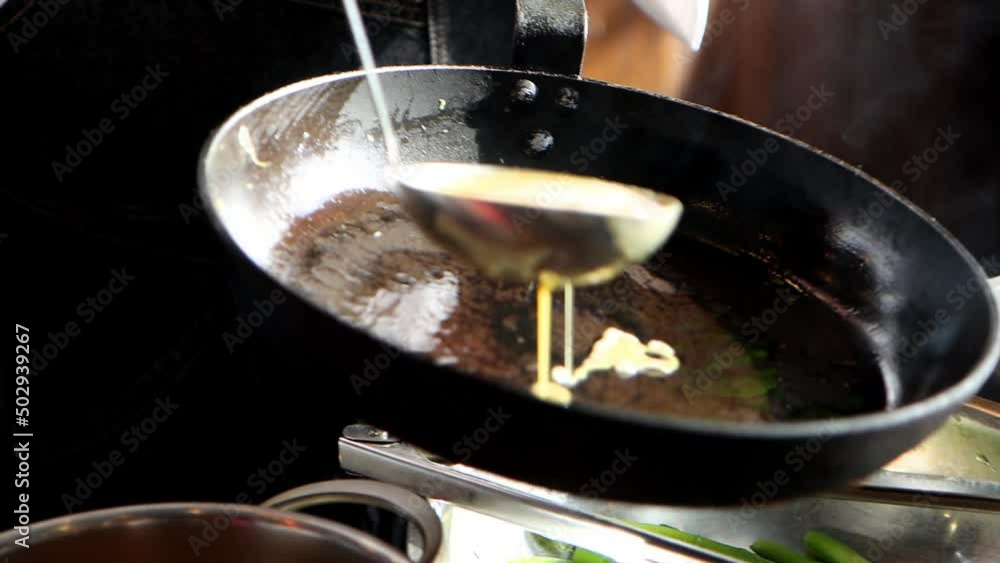 The cook roasts egg pancake on frying pan in the kitchen, close-up 4K video The cook roasts egg pancake on frying pan in the kitchen, close-up 4K video