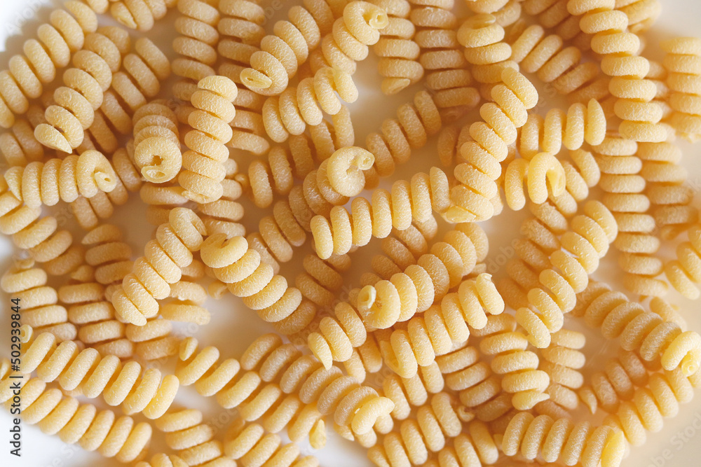 Pasta fusilli bucati corti as background. Uncooked fusilli bucati corti
