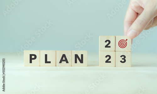 2023 Goal plan action, Business plan and strategies. Business annual plan and development for achieving golas. Goal acheiveement and success in 2023. Placing the wooden cubes with 2023 goals icons.