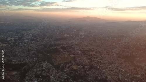 High rise aerial above huge metropolitan area in Africa during sunset. Addis Ababa, Ethiopia