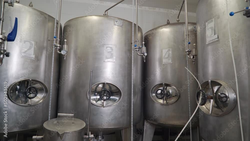 Multiple huge steel containers are used for beer beverage storage ...
