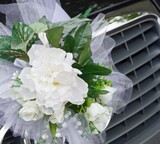 Close-up of decorative white bouquet on car
