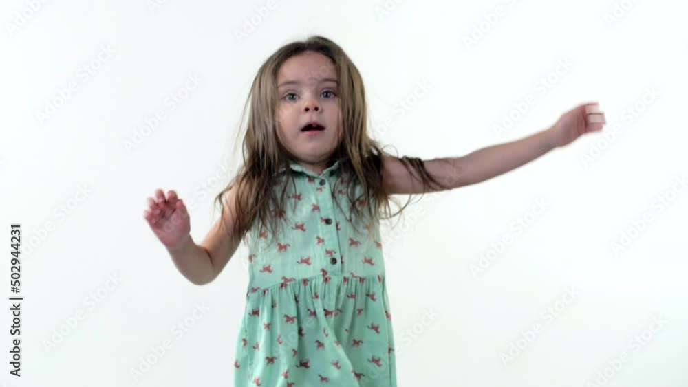 Funny little girl jumps up and laughs. Layer of Motion. White background Funny little girl jumps up and laughs. Layer of Motion. White background