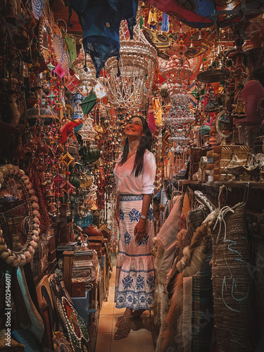 Woman looking at the lamps of a bazar shop at Souq Waqif, Qatar. photo