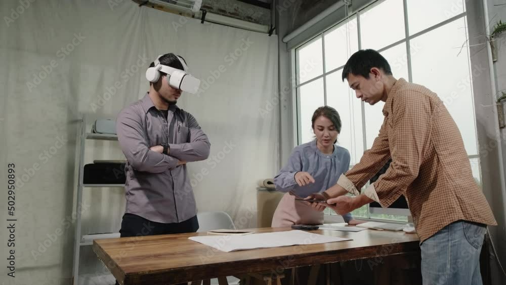 Asian people Architects teamwork using tablet and Virtual Reality headset working with Augmented Reality software application. Augmented reality technology for engineering in the future. Asian people Architects teamwork using tablet and Virtual Reality headset working with Augmented Reality software application. Augmented reality technology for engineering in the future.