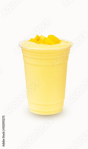 Fresh Mango ripe organic yellow smoothie honey mix with Straw in plastic glass, Garnish. Isolated on white background. Ripe mangoes are popular all over world. Perfect for summer drink. Healthy food. 