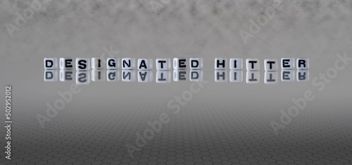 designated hitter word or concept represented by black and white letter cubes on a grey horizon background stretching to infinity