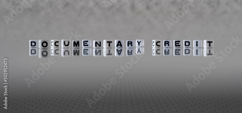 documentary credit word or concept represented by black and white letter cubes on a grey horizon background stretching to infinity