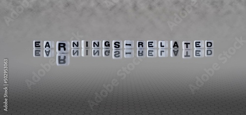 earnings related word or concept represented by black and white letter cubes on a grey horizon background stretching to infinity