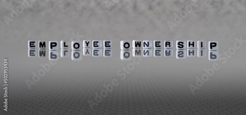 Φωτογραφία employee ownership word or concept represented by black and white letter cubes o