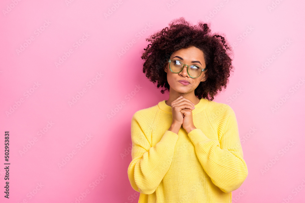 Photo of funny unsure woman dressed kitted pullover glasses looking empty space isolated pink color background Photo of funny unsure woman dressed kitted pullover glasses looking empty space isolated pink color background