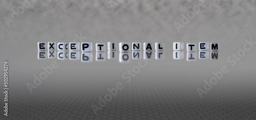 exceptional item word or concept represented by black and white letter cubes on a grey horizon background stretching to infinity