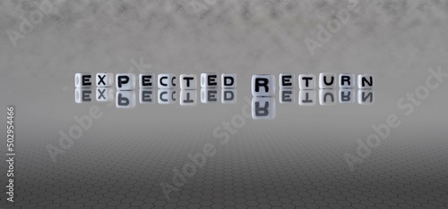 expected return word or concept represented by black and white letter cubes on a grey horizon background stretching to infinity