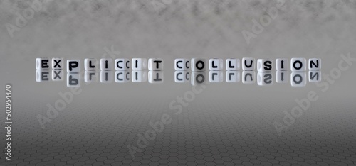 explicit collusion word or concept represented by black and white letter cubes on a grey horizon background stretching to infinity photo