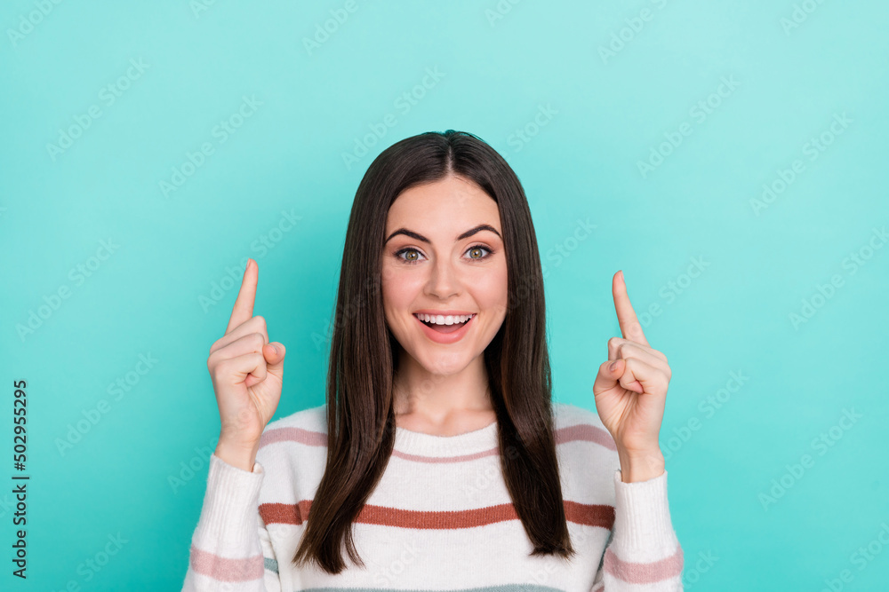 Photo of positive promoter lovely lady direct finger empty space wear striped pullover isolated blue color background Photo of positive promoter lovely lady direct finger empty space wear striped pullover isolated blue color background