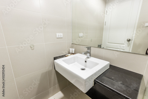 Clean and white bathroom with amenities.