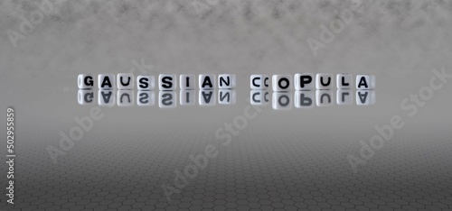 gaussian copula word or concept represented by black and white letter cubes on a grey horizon background stretching to infinity