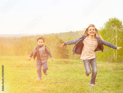 children running across the field outdoors in the sunshine