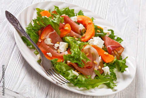 pumpkin salad with lettuce, crumbled cheese, ham