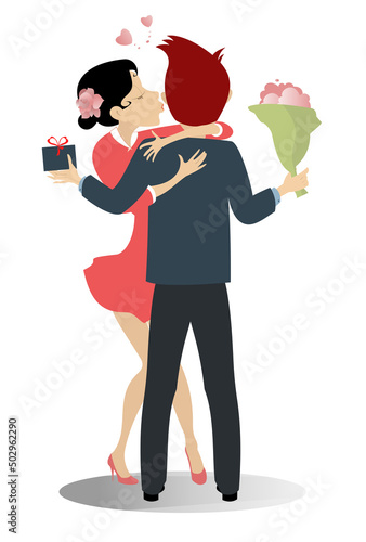 Kissing love couple isolated. Pretty young woman is kissing the boyfriend who holds a present and a bouquet of flowers © bigmen