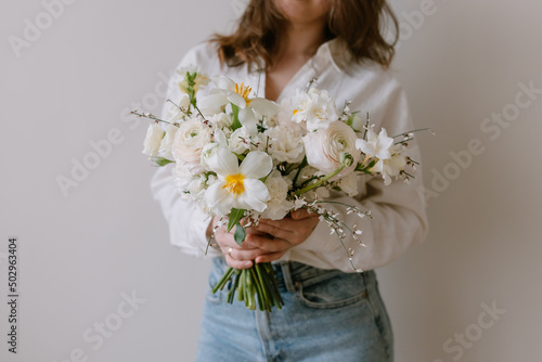 Beautiful bouquet of flowers in female hands. Spring plants.