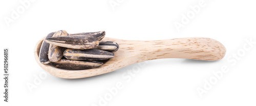 Sunflower seeds with wooden spoon isolated on white background.