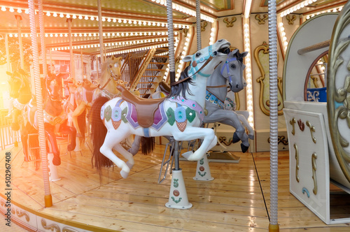Carousel with horses at the fun fair.