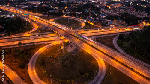 circle road traffic in roundabout and highway at night long exposure shot from drone © SHUTTER DIN