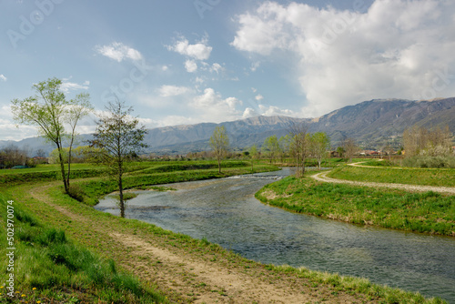 Italian rural landscape. Meschio River with hills in the background. Cordignano, Treviso, Italy.
