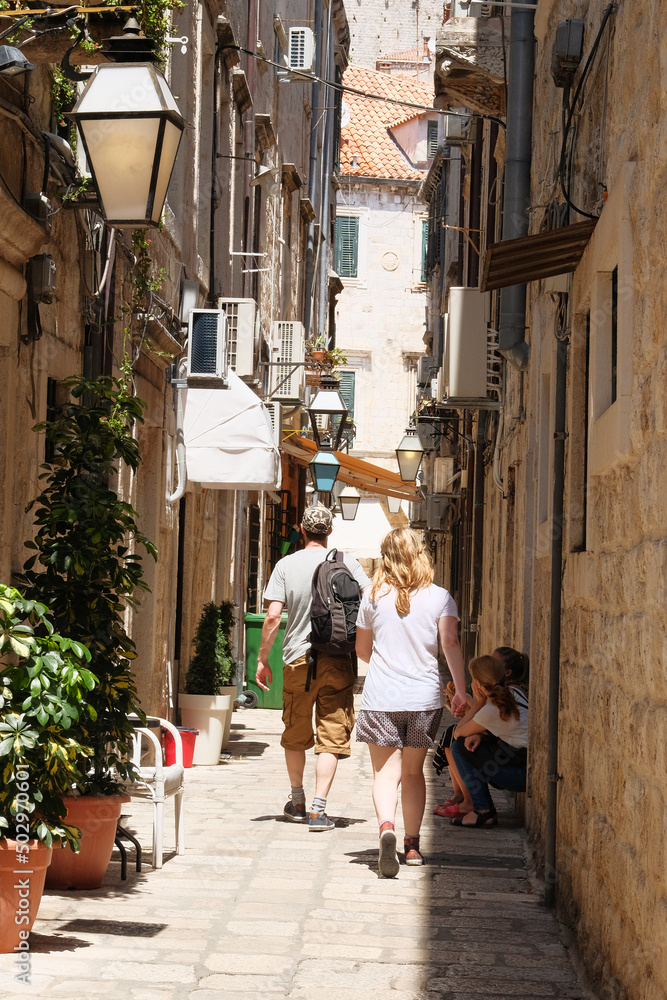 Walk between walls of houses. Passage between walls to the old town and stairs, the historical part of the city. Summer in Croatia, Dubrovnik. Walk between walls of houses. Passage between walls to the old town and stairs, the historical part of the city. Summer in Croatia, Dubrovnik.
