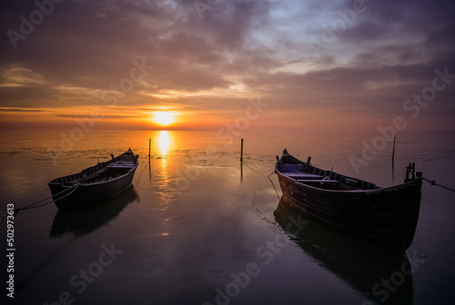 fishing boats at sunrise in winter