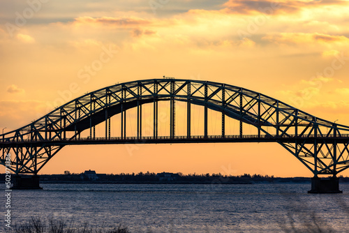 Golden sunset light over a steel tied arch bridge. Fire Island Inlet Bridge, Captree State Park New York © Scott Heaney