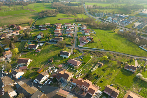 Aerial view of residential houses in green suburban rural area