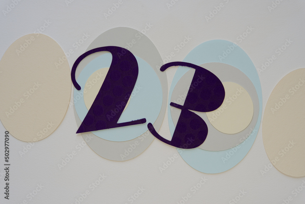 the number 23 or (two and three) on grungy paper oval shapes on a blank surface the number 23 or (two and three) on grungy paper oval shapes on a blank surface