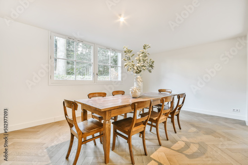 Dining room interior with classy wooden table and chairs