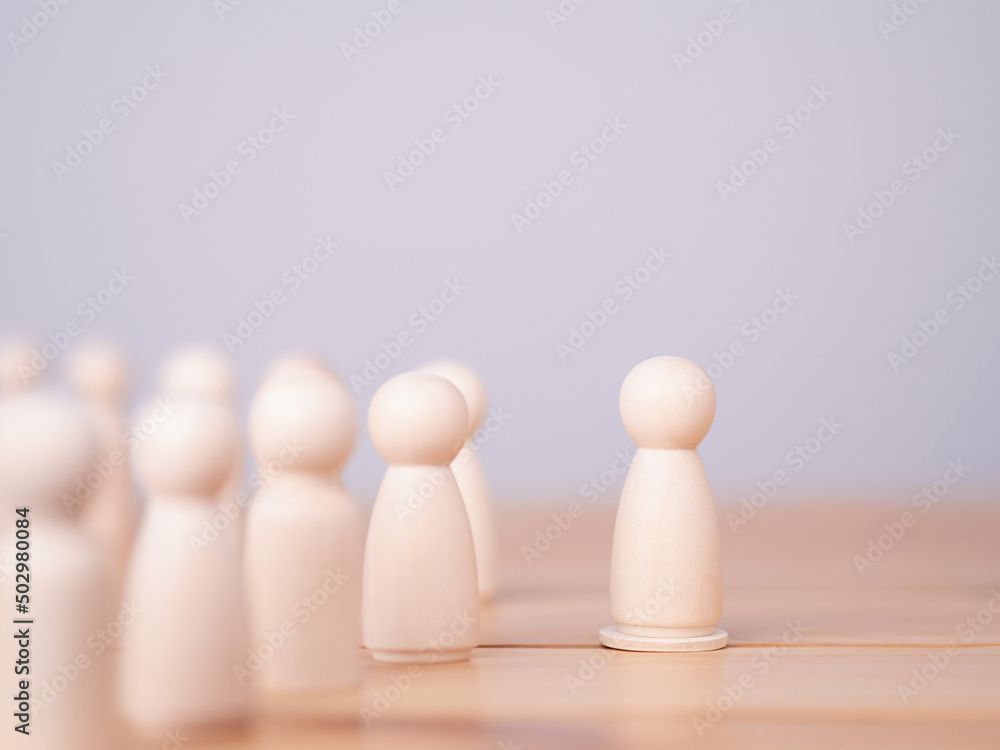 Concept of leadership, lead, inspire, empower, business, manager, teamwork, vision, strategy, influence, competition. Wooden doll or figure standing on wooden cube leading the team Concept of leadership, lead, inspire, empower, business, manager, teamwork, vision, strategy, influence, competition. Wooden doll or figure standing on wooden cube leading the team