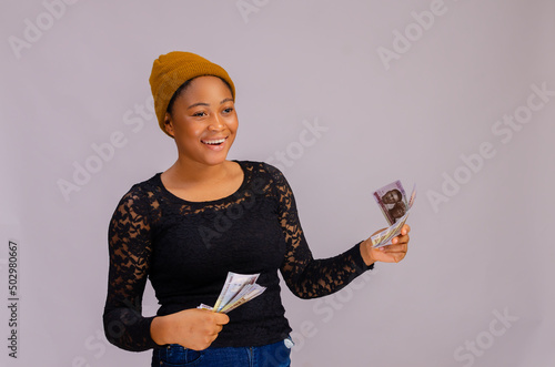 beautiful african lady happy at the money on her hand