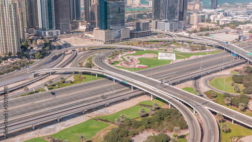 Aerial view on Dubai Marina with big highway intersection timelapse and skyscrapers around, UAE