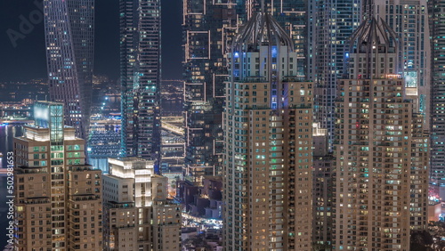 Skyscrapers of Dubai Marina near intersection on Sheikh Zayed Road with highest residential buildings night timelapse