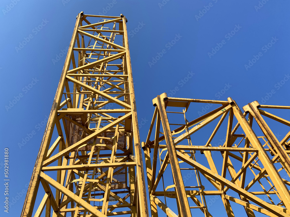 construction tower at a construction site on blue sky background. Industry new building business.