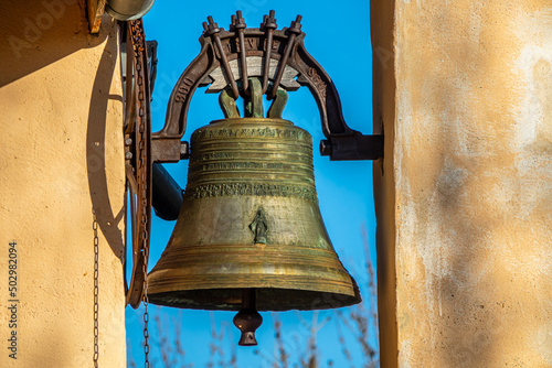 Pretty and large bell decorated with a motif, on an old church in a small mountain village.  Southern Alps, France.