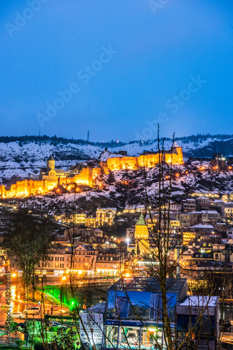 Fototapeta Naklejka Na Ścianę i Meble -  Snowing in Tbilisi city in the evening
