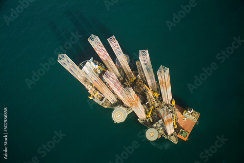 Aerial view of a semi-submersible cargo ship with 3 drilling platforms on board photo
