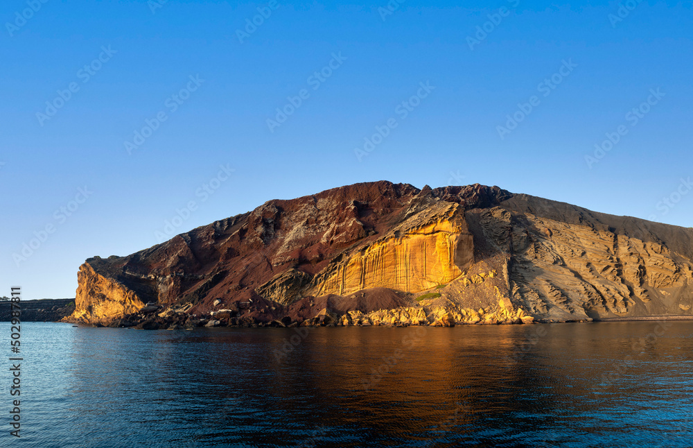 Fototapeta premium The Linosa volcano called Monte Nero in the beach of Cala Pozzolana di Ponente, Sicily