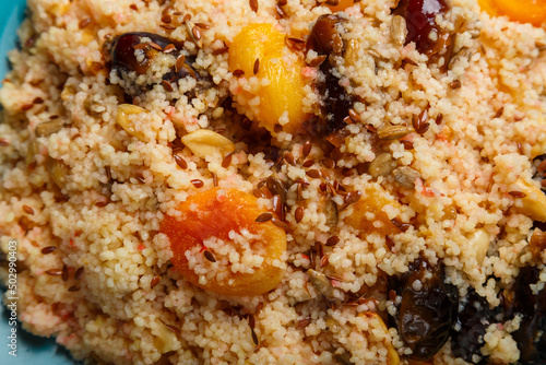 cous cous with dried fruits saffron and nuts depraved close-up.