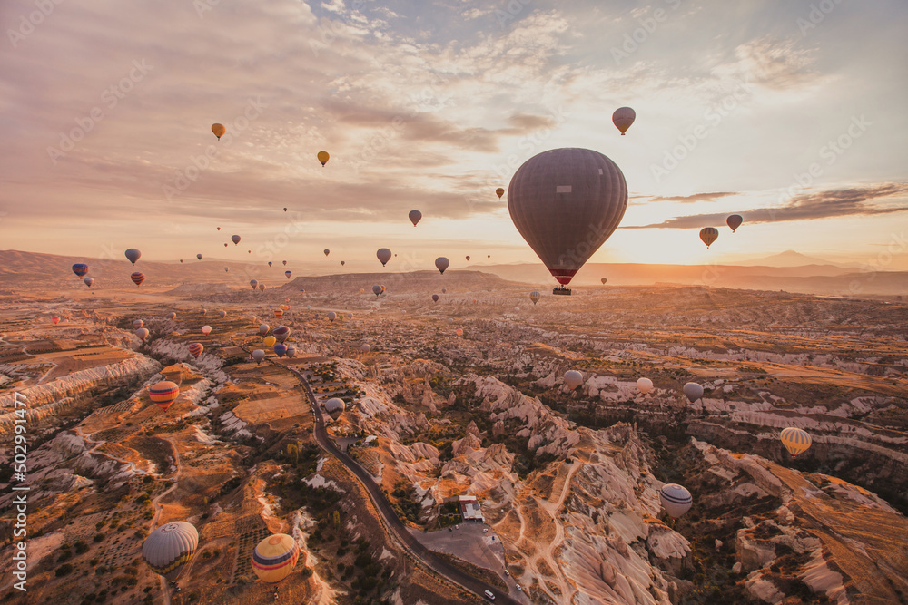 travel and inspiration, hot air ballons in Turkey flying at sunrise sky - obrazy, fototapety, plakaty 
