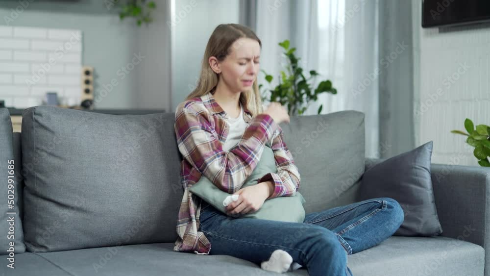 frustrated sad girl crying at home on the couch. young depressed woman alone indoors. Female in physical emotional pain suffering from bad toxic relationship, upset negative thoughts or mental disease frustrated sad girl crying at home on the couch. young depressed woman alone indoors. Female in physical emotional pain suffering from bad toxic relationship, upset negative thoughts or mental disease