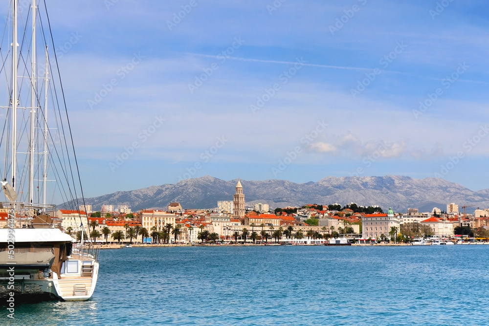 Promenade in Split, Croatia with landmark architecture and sailing boats. 