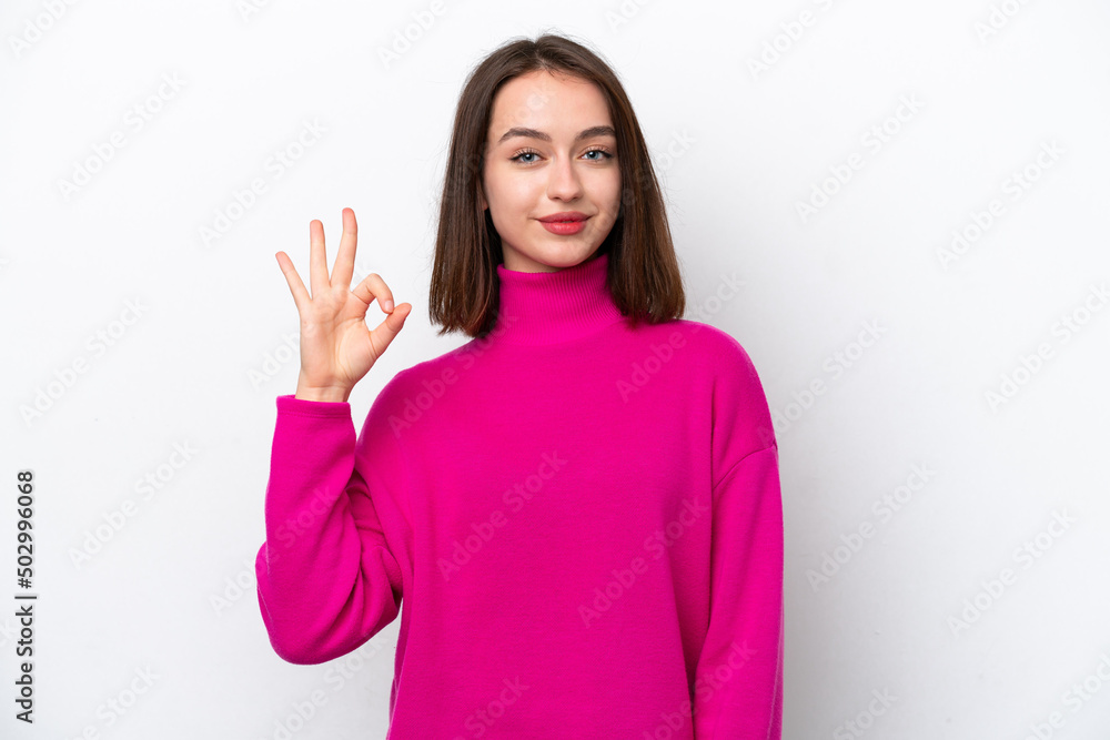 Young Ukrainian woman isolated on white background showing ok sign with fingers Young Ukrainian woman isolated on white background showing ok sign with fingers