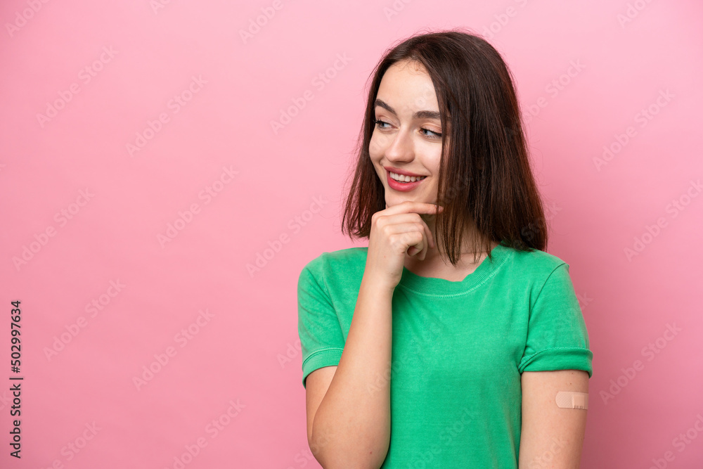 Young Ukrainian woman wearing a band aids thinking an idea and looking side Young Ukrainian woman wearing a band aids thinking an idea and looking side